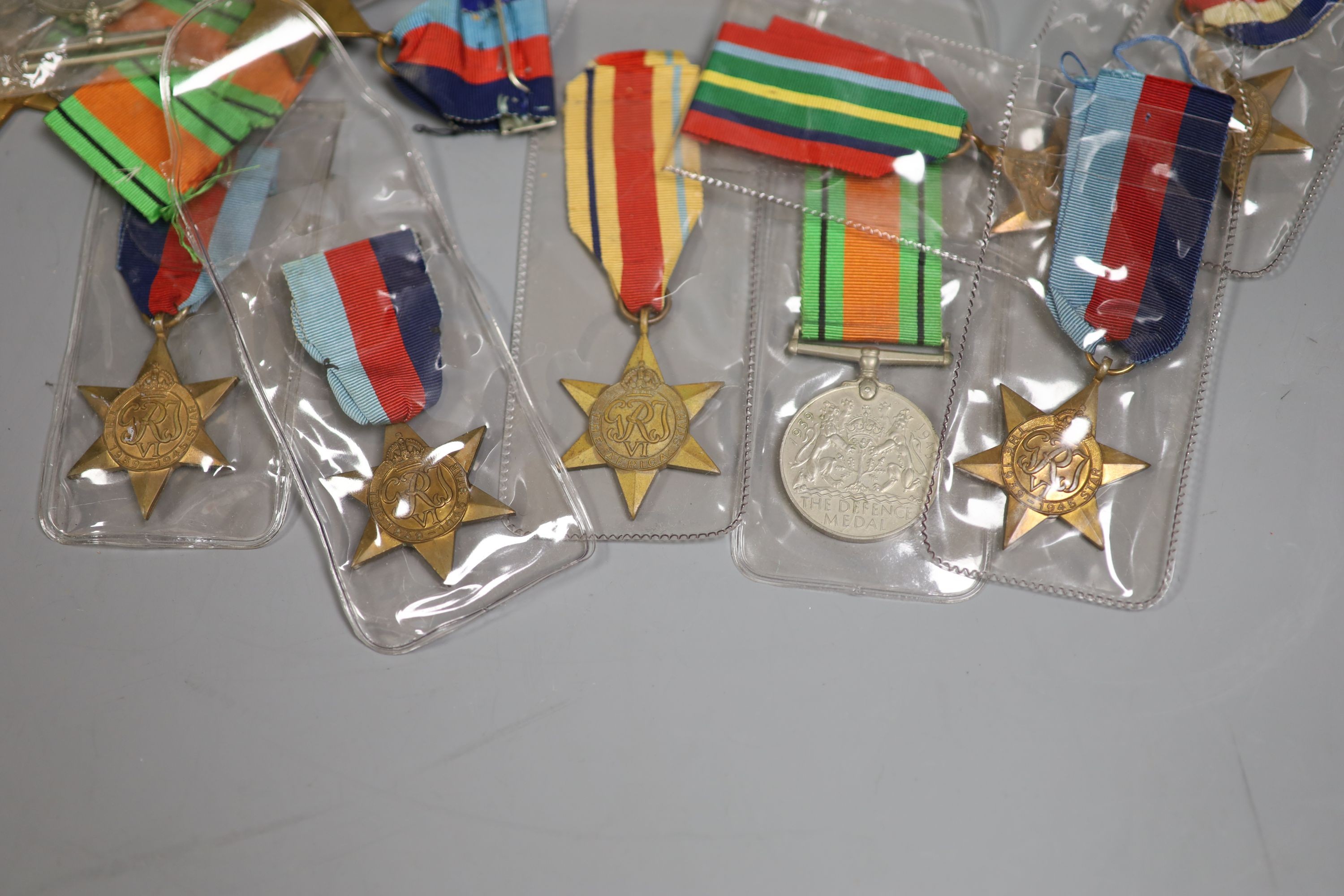 A large collection of unnamed WWII medals and spare ribbons and a cased QEII Imperial Service Medal to John Henry Hope